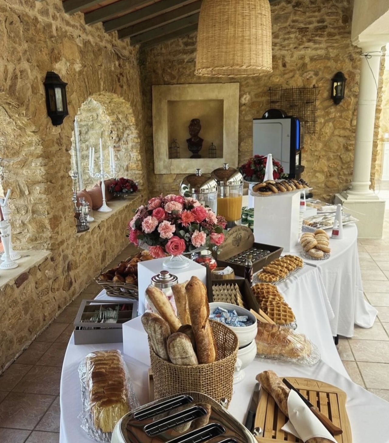Day-after wedding brunch buffet beneath the stone arches of La Pousterle