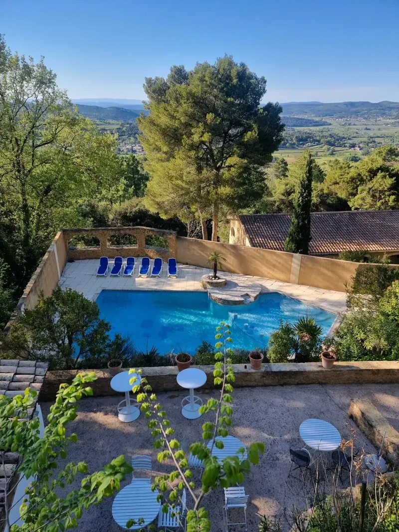 Heated pool framed by olive trees at La Pousterle de Sabran