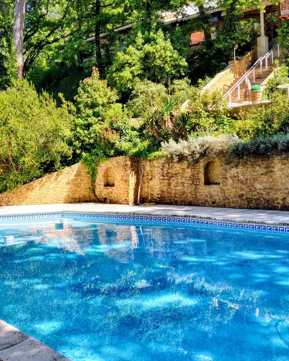The heated pool at La Pousterle de Sabran, between dry-stone walls and garden, deep in the garrigue of the Gard