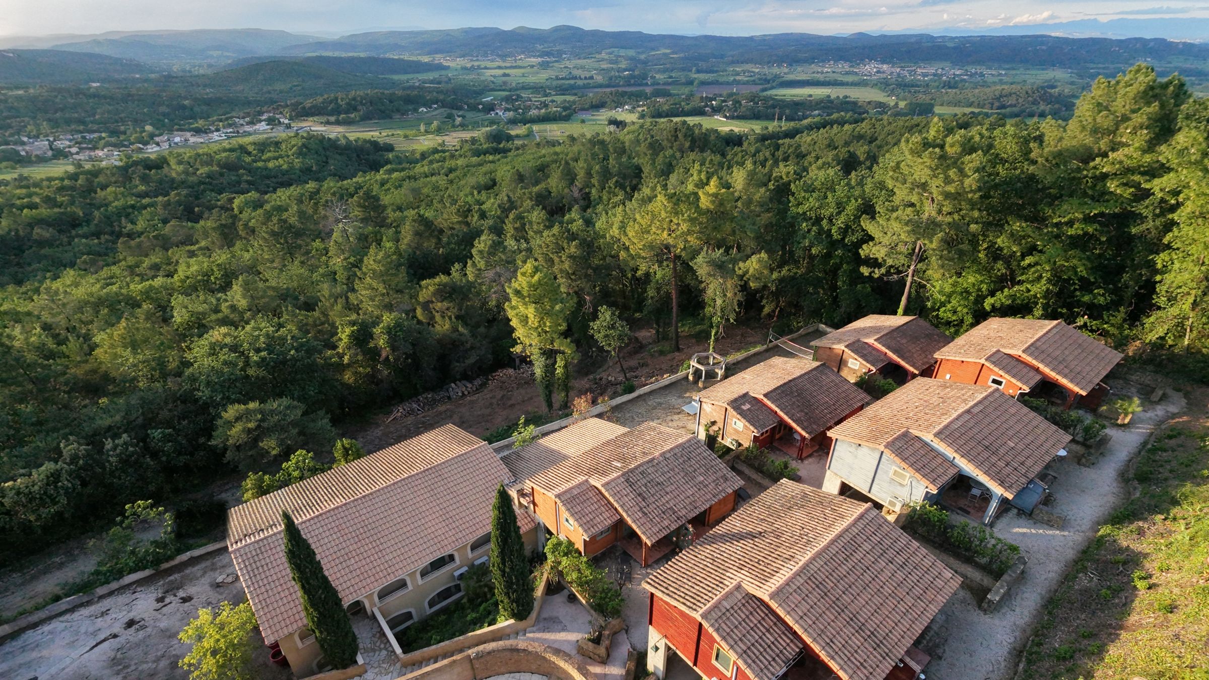 Aerial view of La Pousterle de Sabran, a village of 18 holiday cottages, at sunset, looking out over the Gard valley